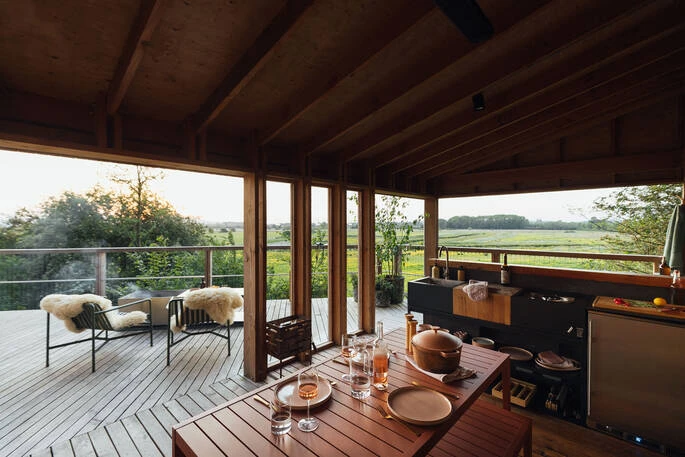 The kitchen and dining area open directly onto the deck.